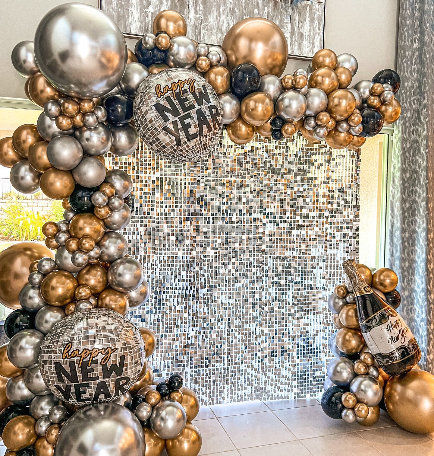 New Years Eve themed balloon garland backdrop with gold and silver balloons