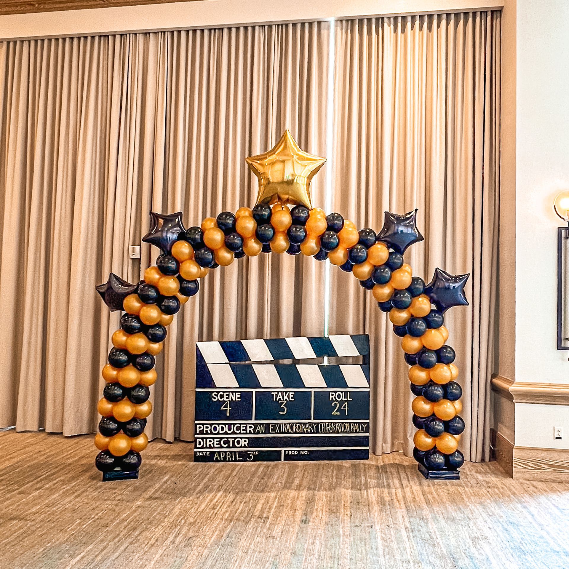 A room decorated with balloons and a clapper board.