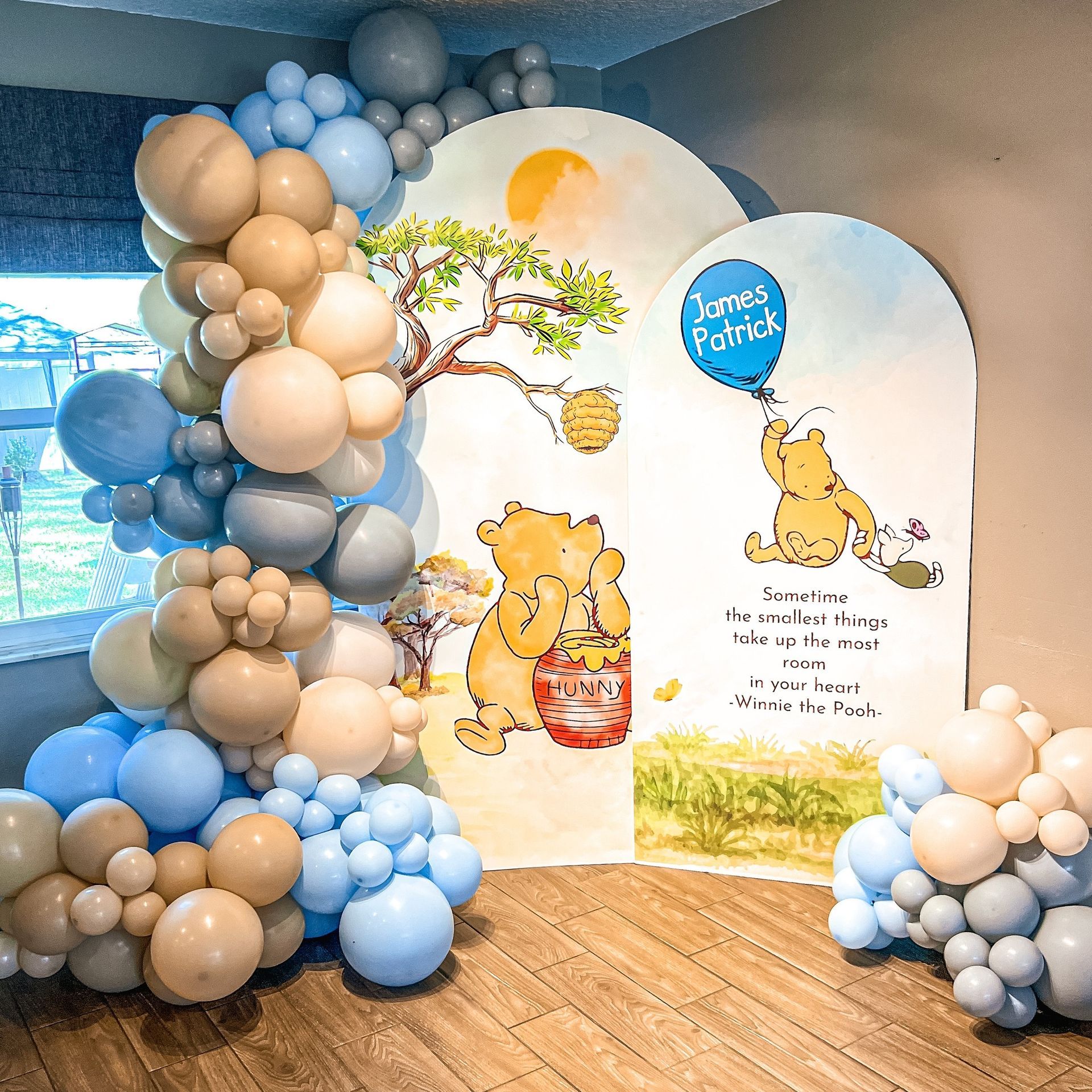 A room filled with balloons and a picture of winnie the pooh