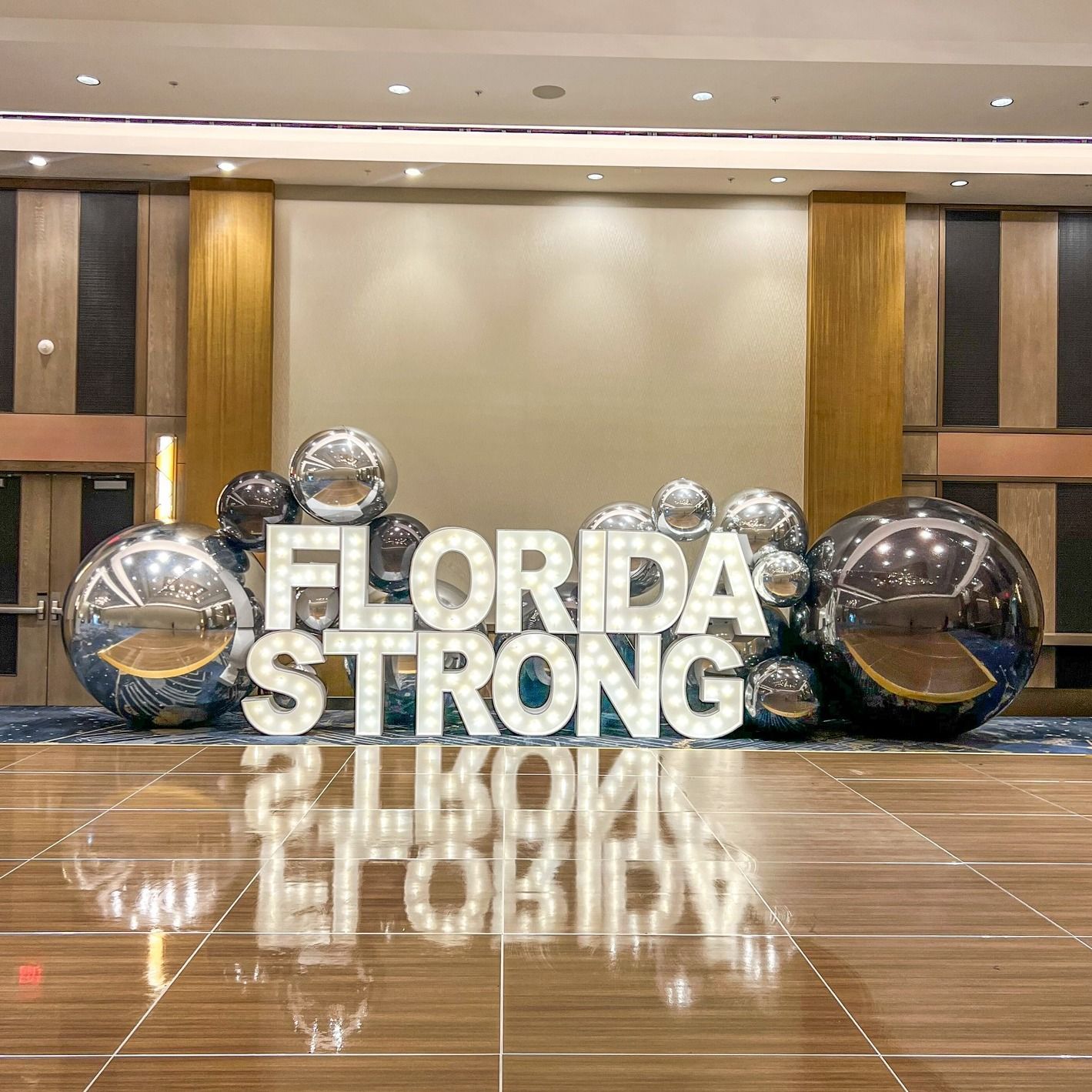 A large room with a dance floor and a sign that says `` florida strong ''.