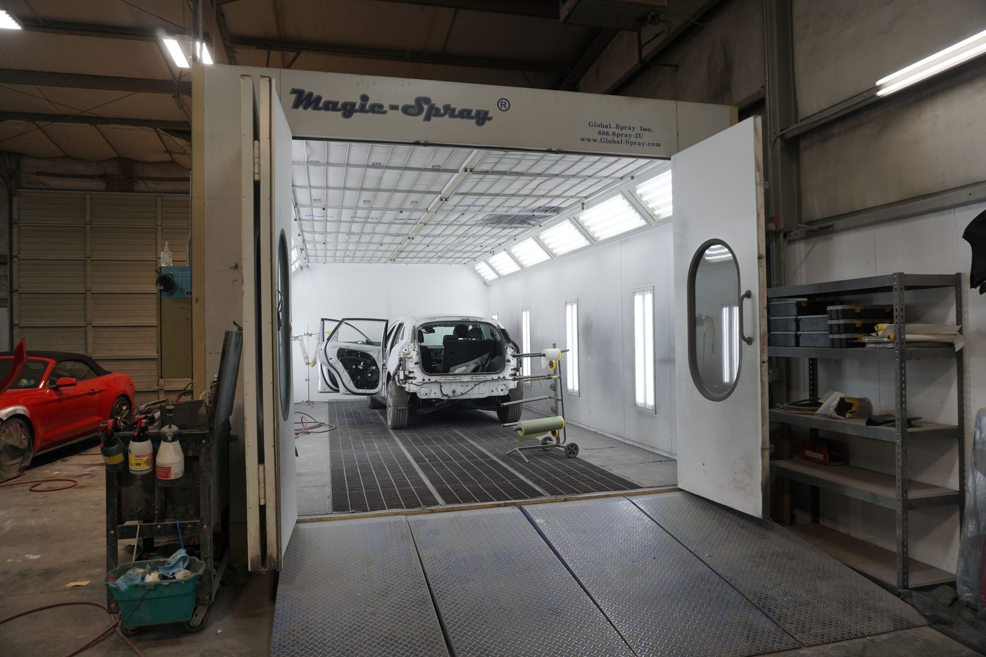 Customer car in Kingston Collison's painting bay getting it paint matched after a collision.