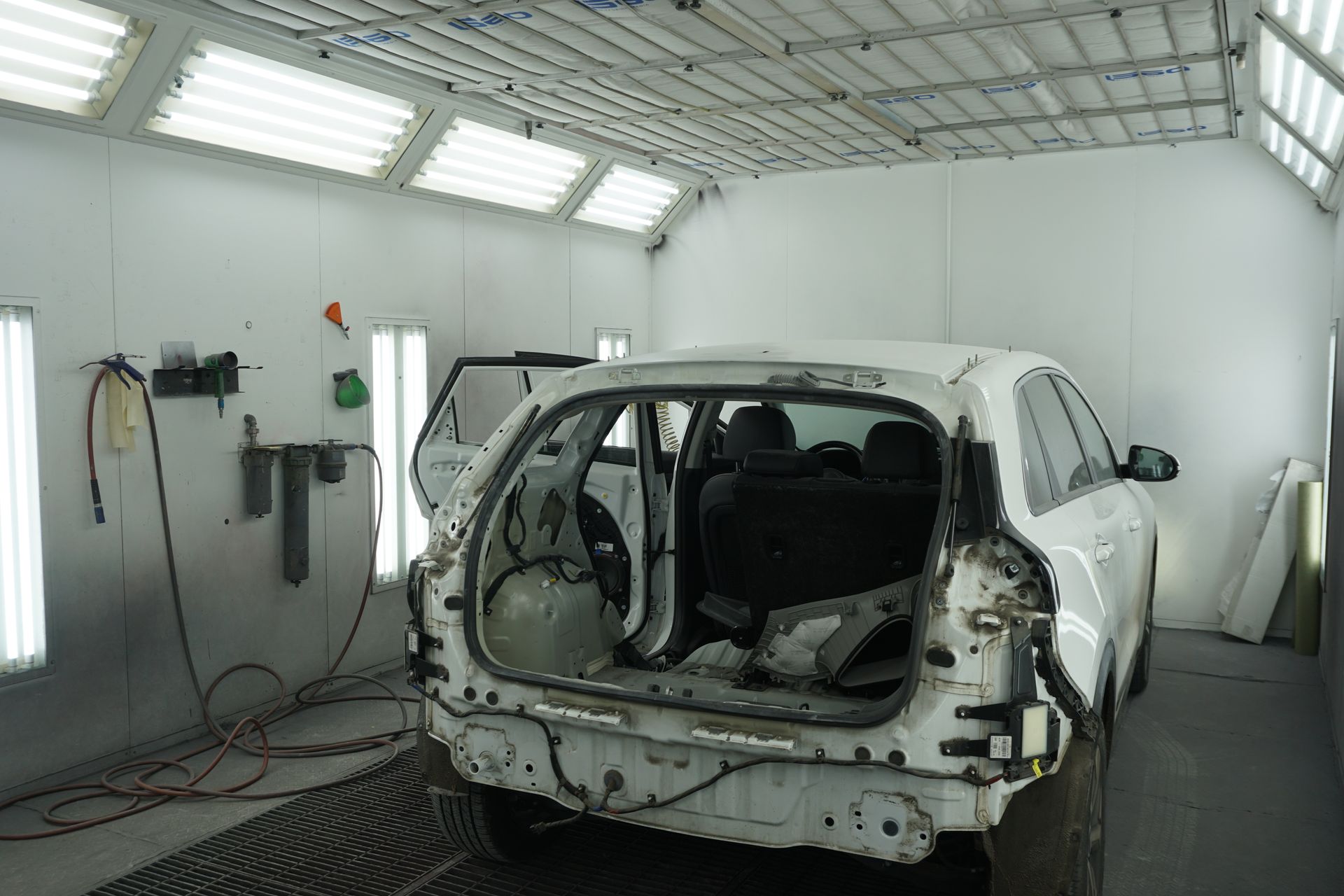 Black car on a white lit surface against a black background.