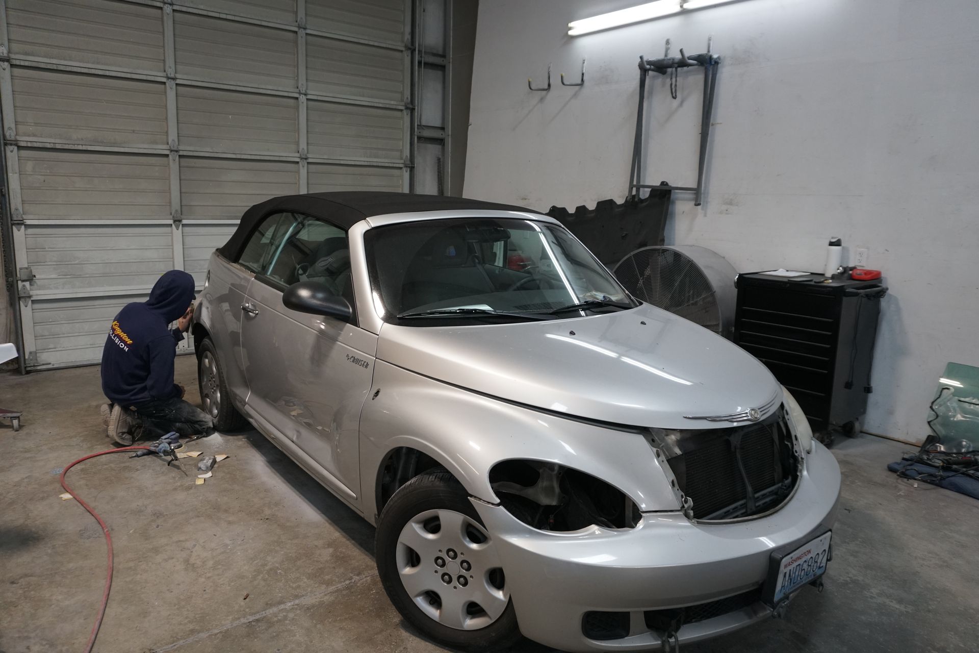 Orange SUV on a black background, front view.