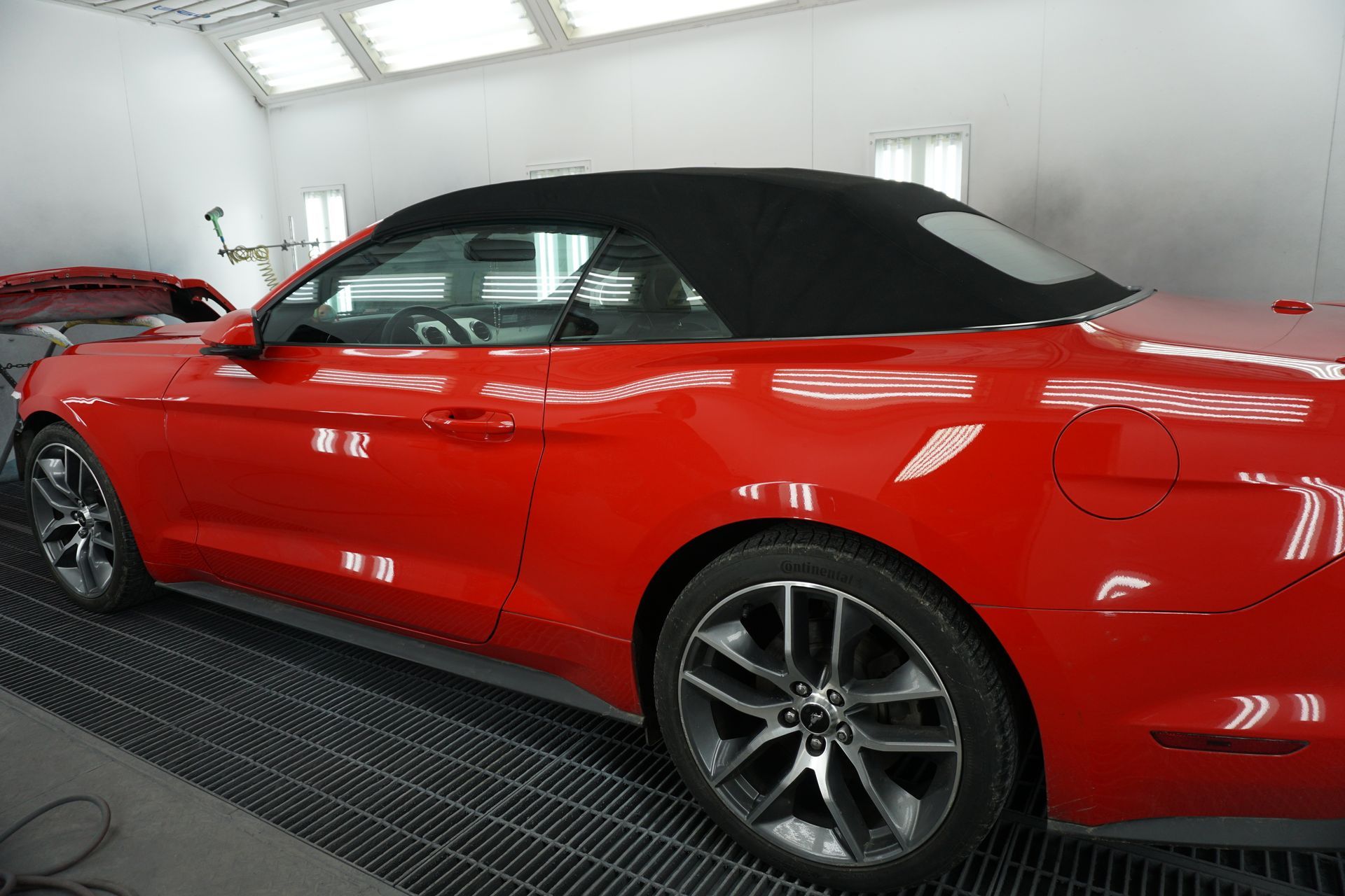 Customer car in Kingston Collison's painting bay getting it paint matched after a collision.