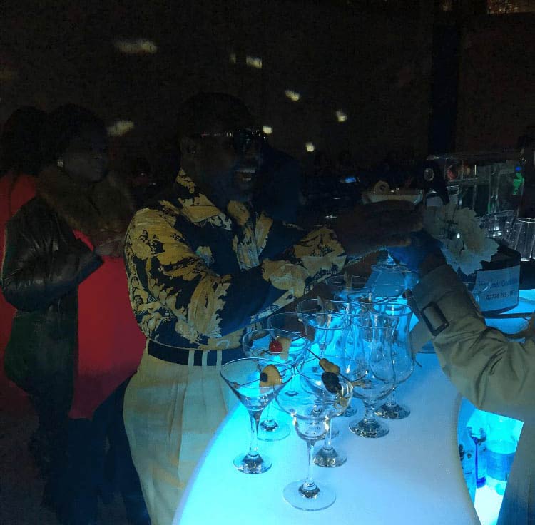 cocktail glasses on bar with blue light