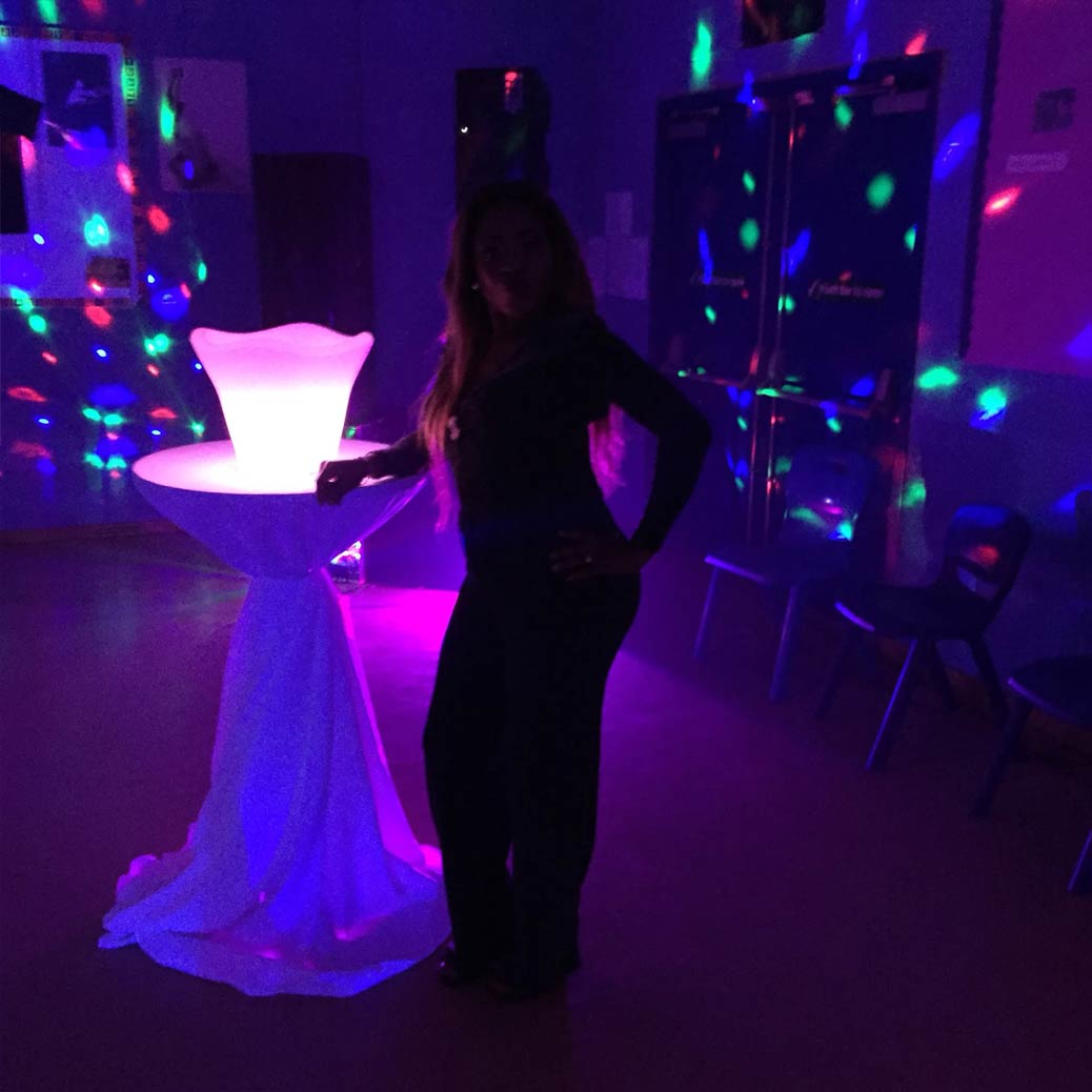 woman posing next to cocktail table
