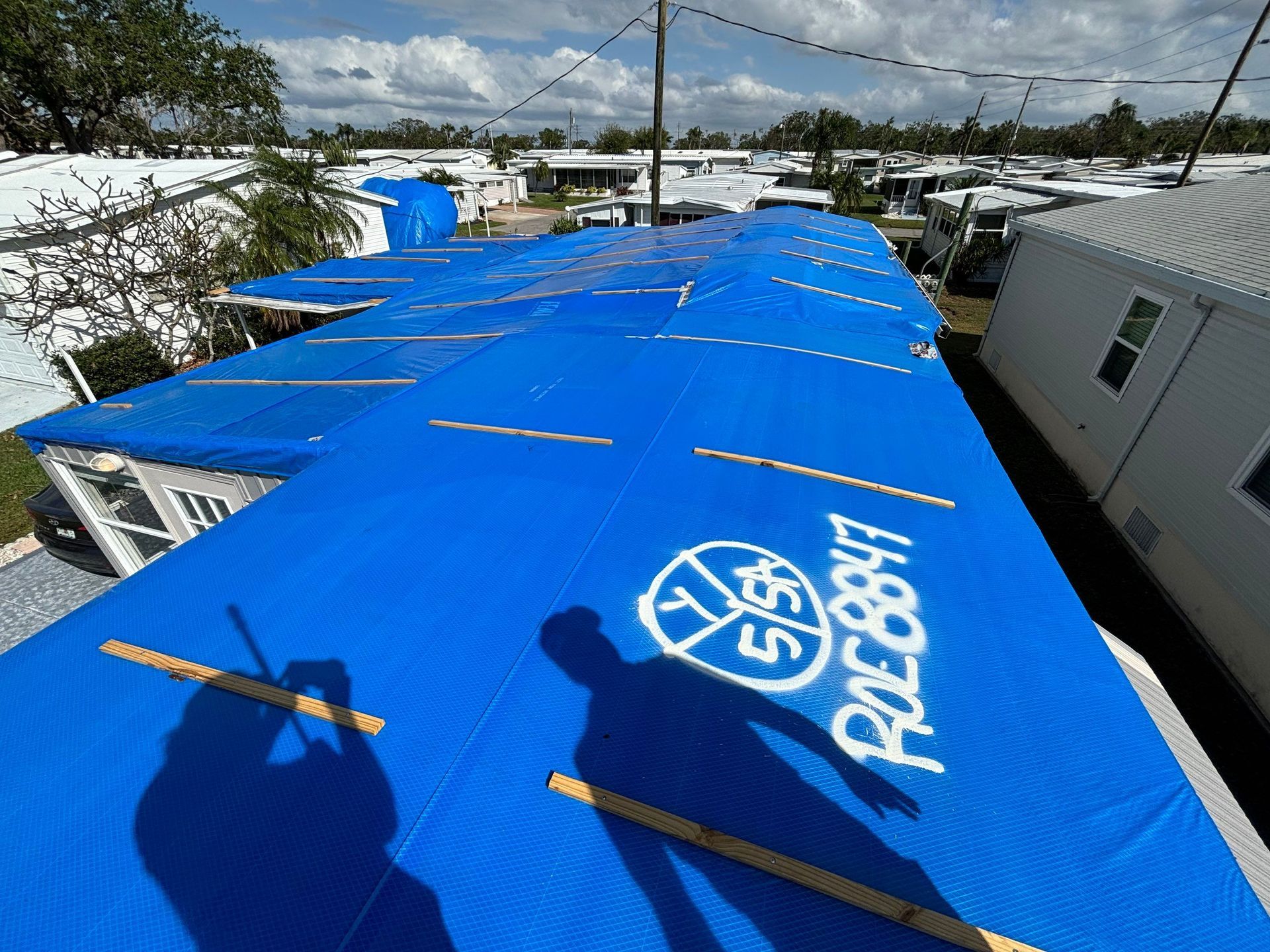 Group of people in matching shirts in front of a trailer labeled