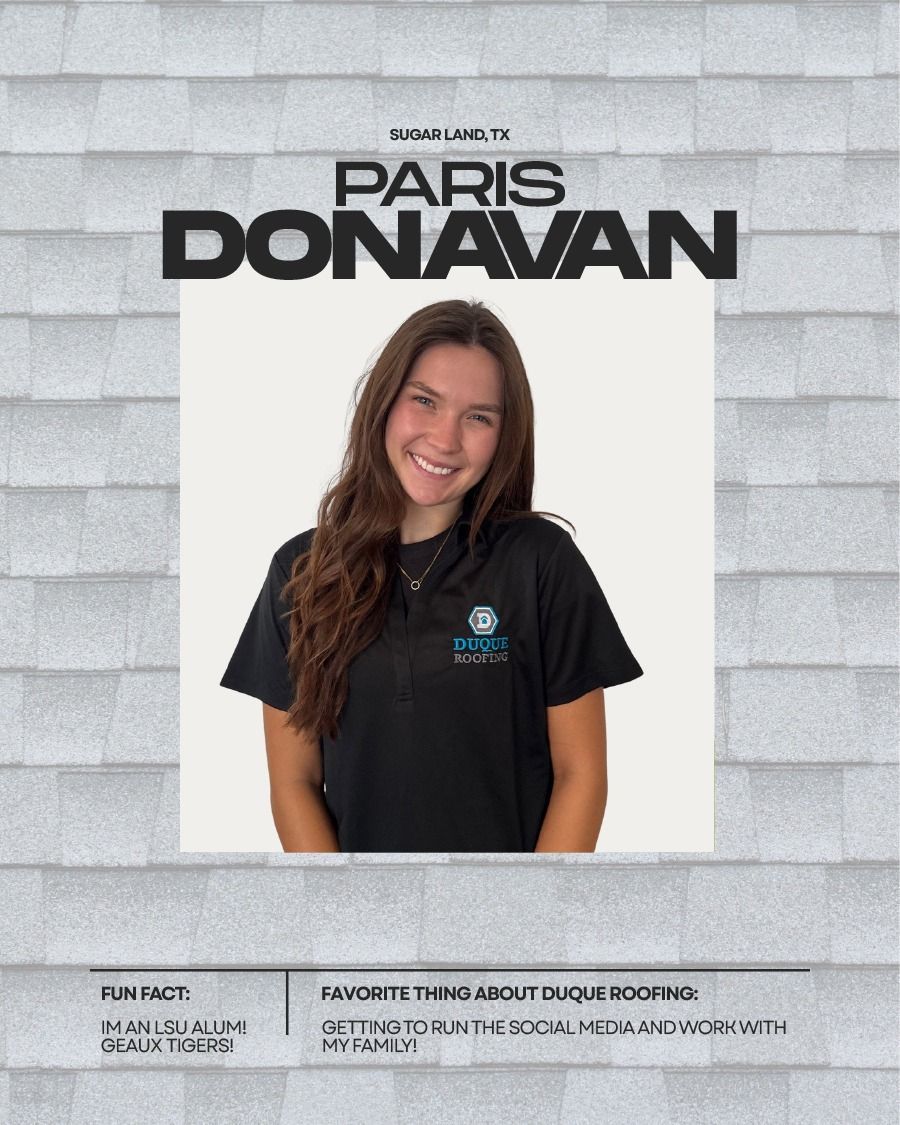 Paris Donavan, smiling, wearing a black shirt with a logo, in front of a shingle background.