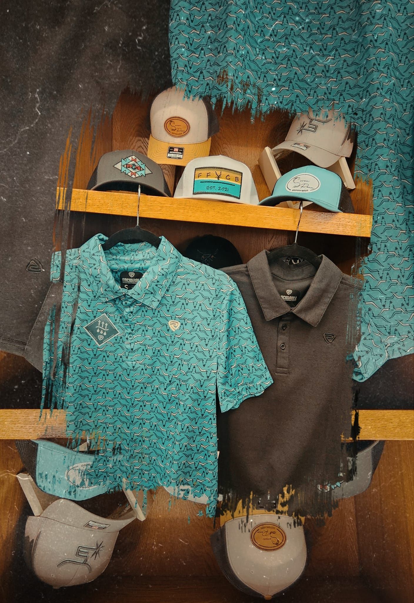 A bunch of hats and shirts are hanging on a shelf.