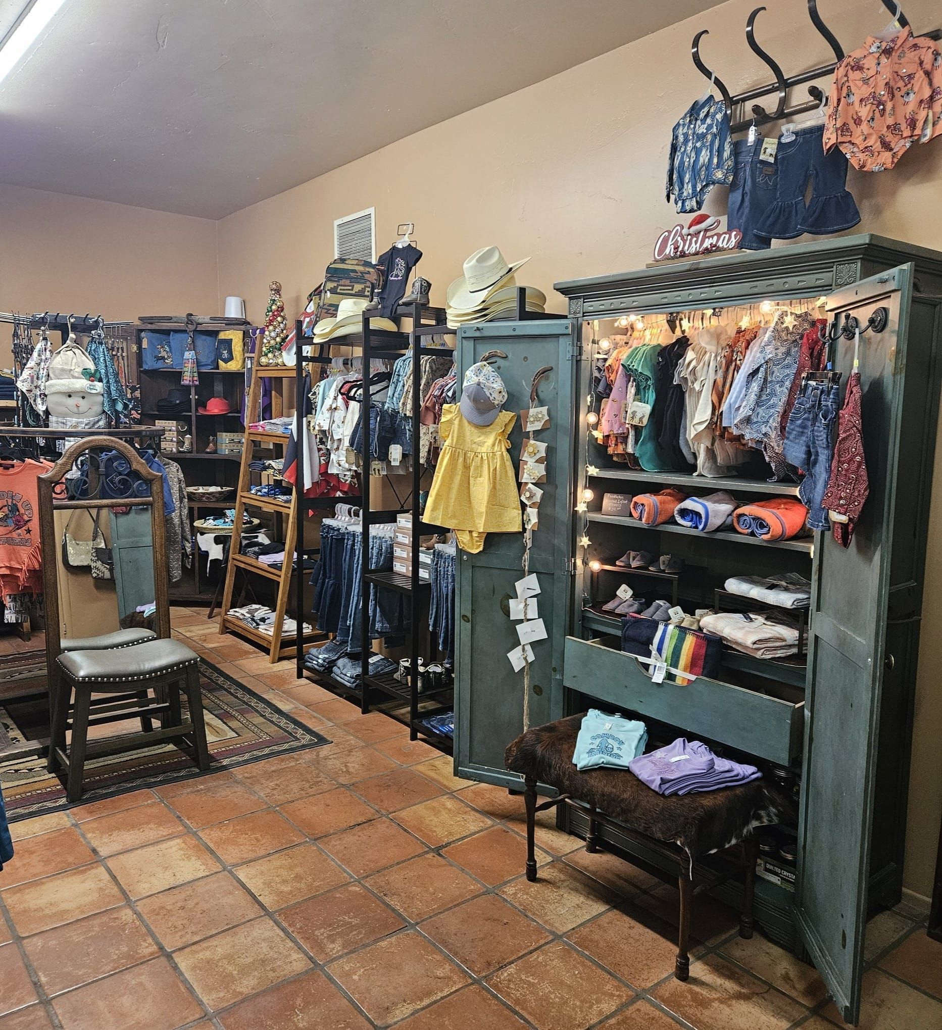 A store filled with lots of clothes including a yellow shirt