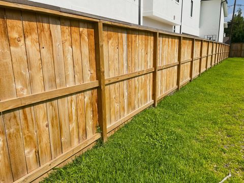 a wooden fence in front of a house
