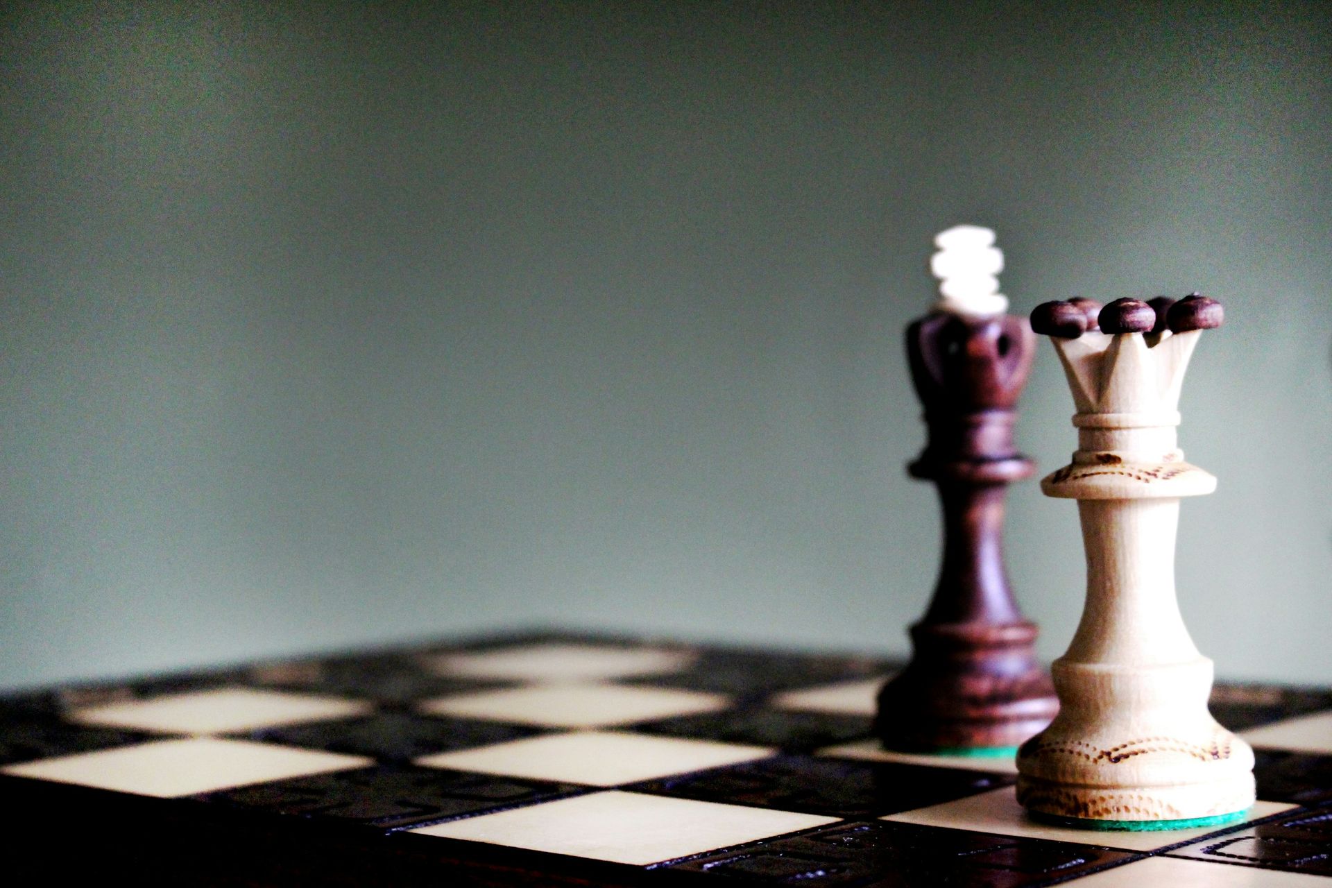 A couple of chess pieces sitting on top of a chess board