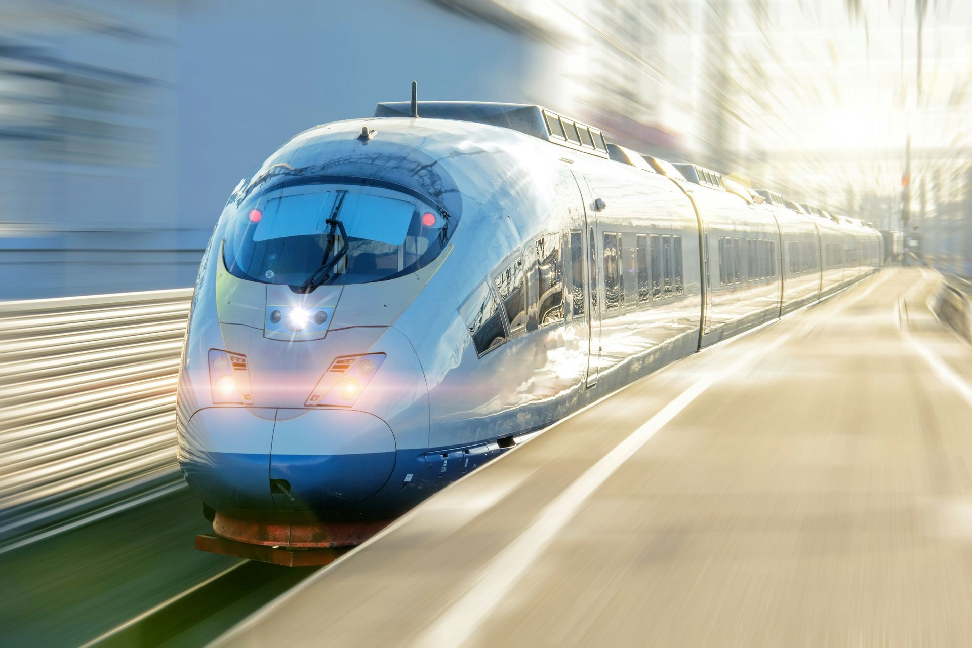 A high speed train is pulling into a train station.