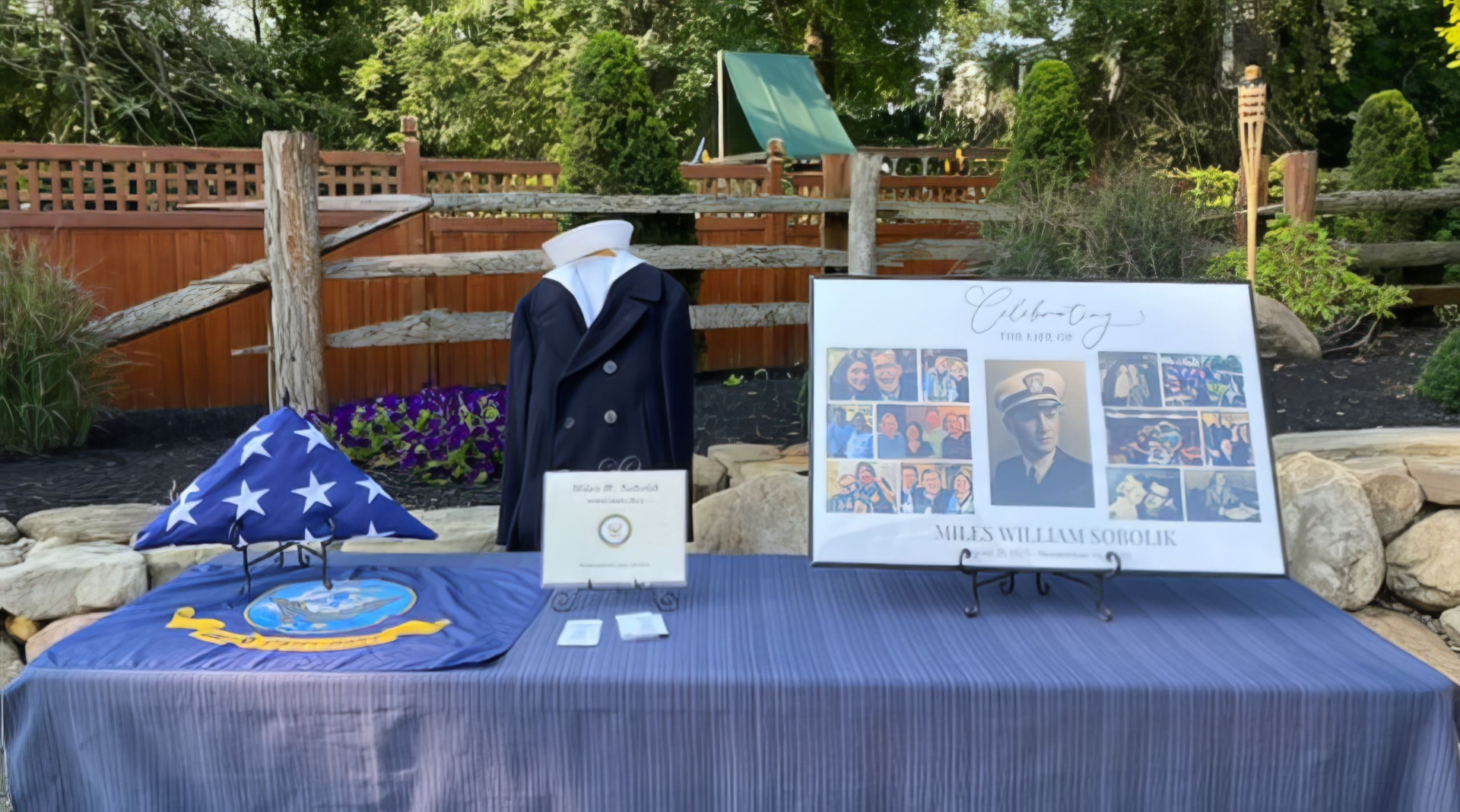 A table with a flag , a jacket , and a sign on it.