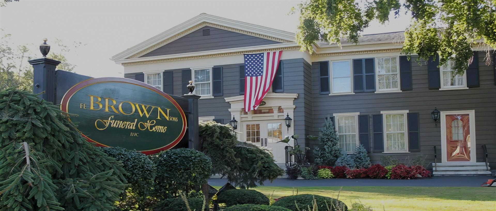 A large house with a sign in front of it that says brown