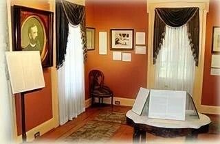 A room with a table and a picture on the wall