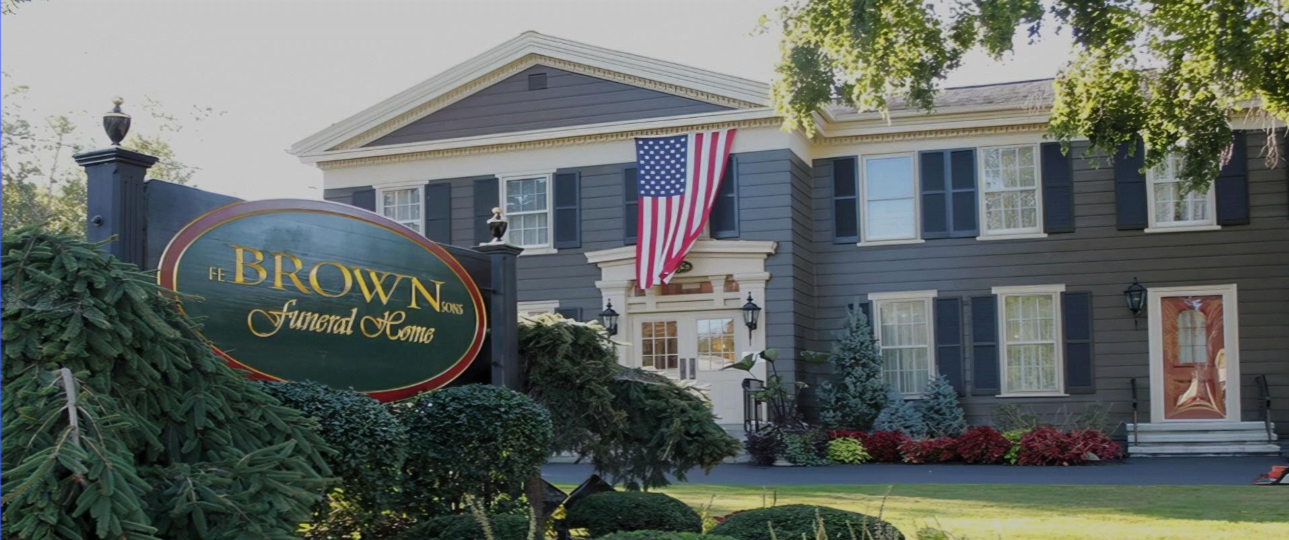 A large house with a sign in front of it that says brown