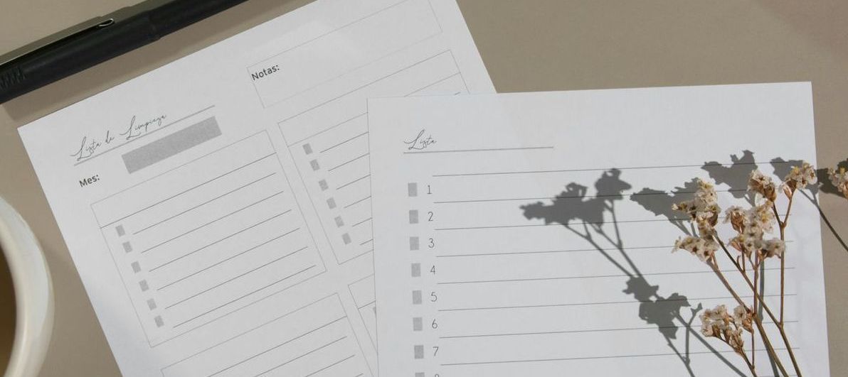 A piece of paper is sitting on a table next to a cup of coffee and a pen.