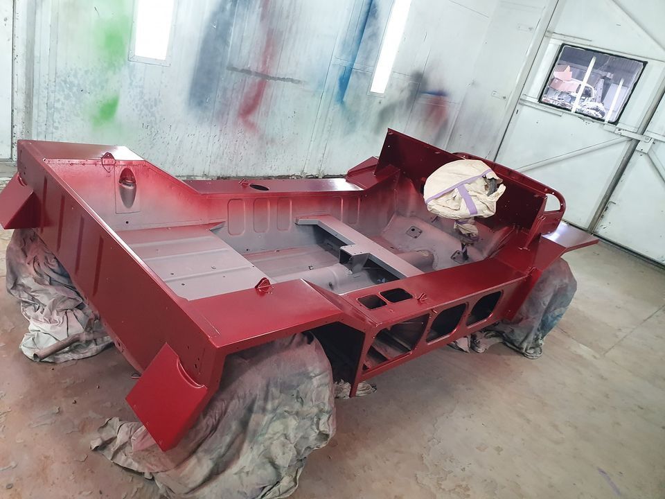 A Red Car is Being Painted in a Garage — Stengels Crash Repairs In Garbutt, QLD