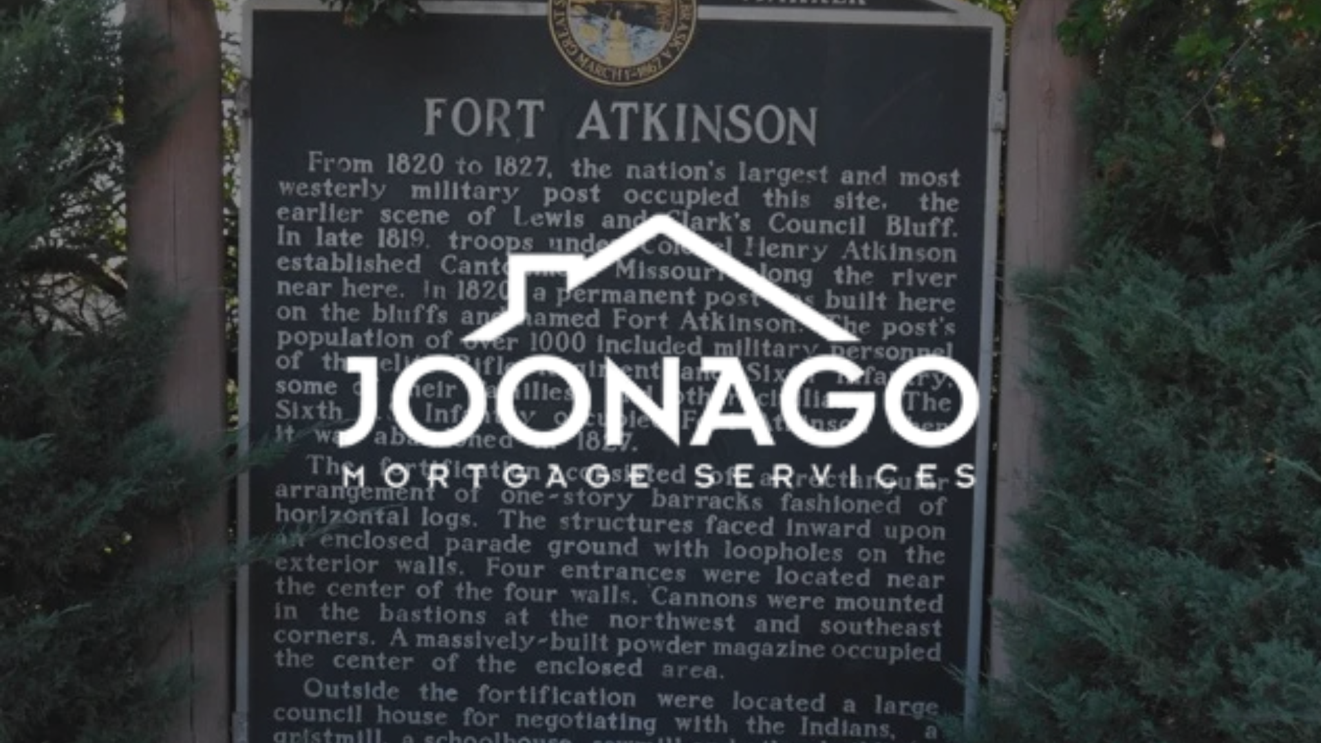 A sign that says fort atkinson on it with joonago mortgage services logo on on top