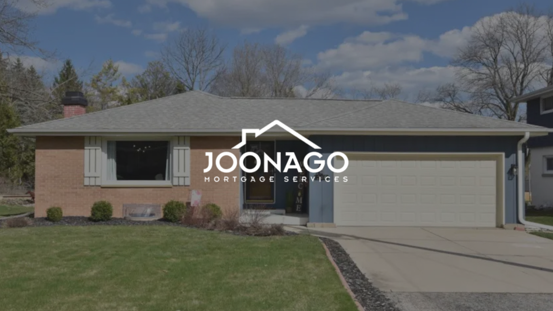 A brick house with a white garage door and a logo for joonago mortgage services