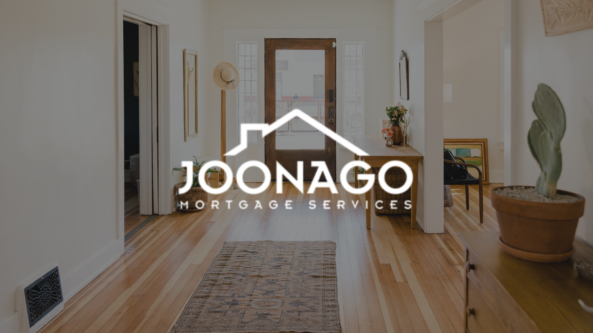 A hallway in a house with a logo for joonago mortgage services.