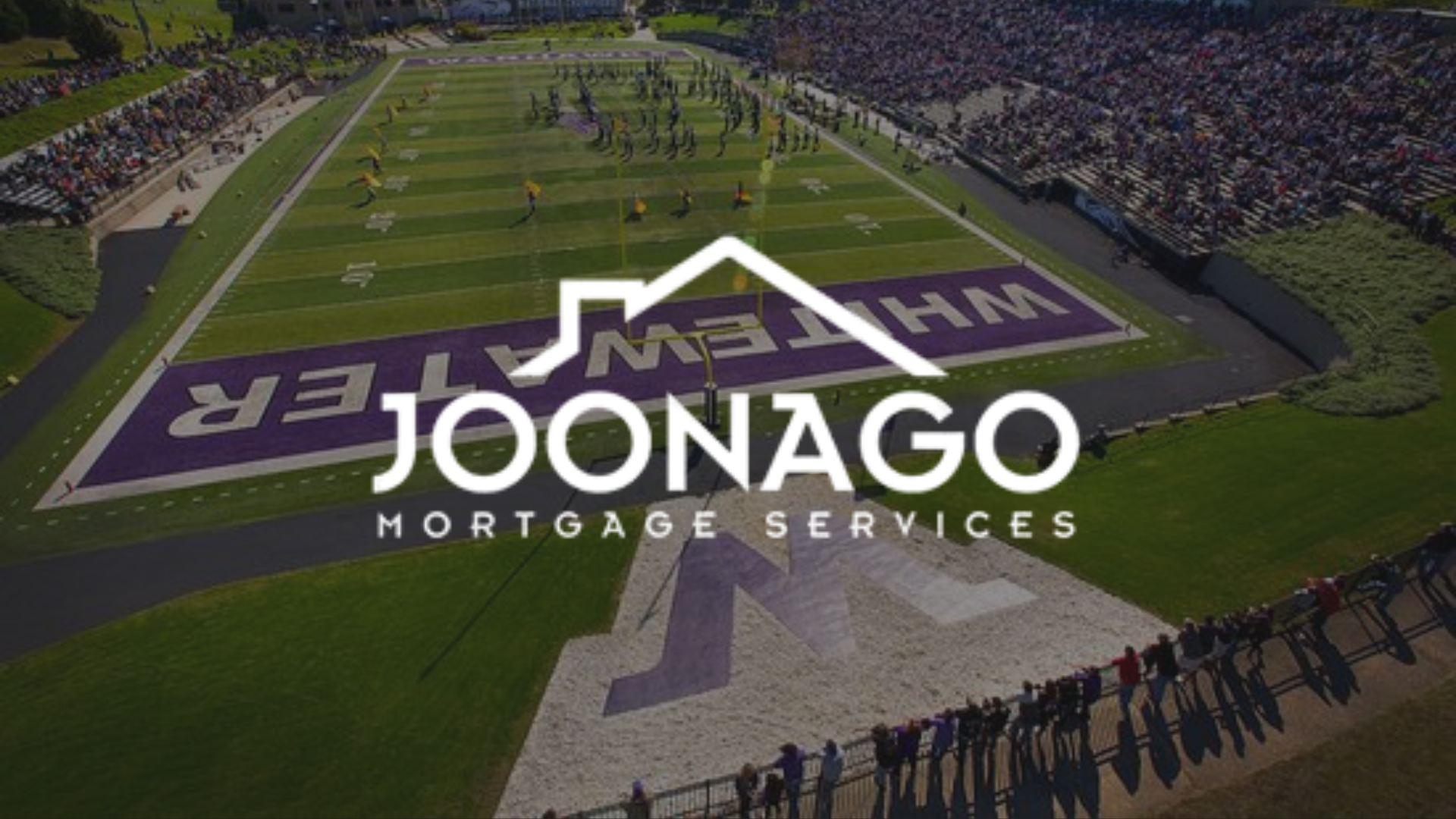 An aerial view of the whitewater wi football field with the logo for joonago mortgage services.