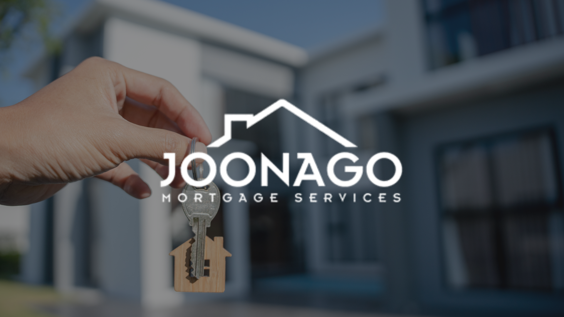 Hand holding house keys with