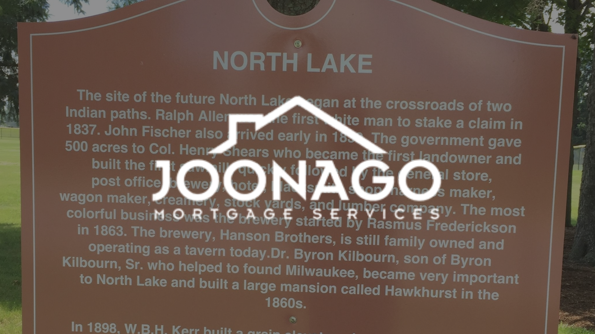 Sign for North Lake, with text about its history. JOONAGO logo partially obscures text.