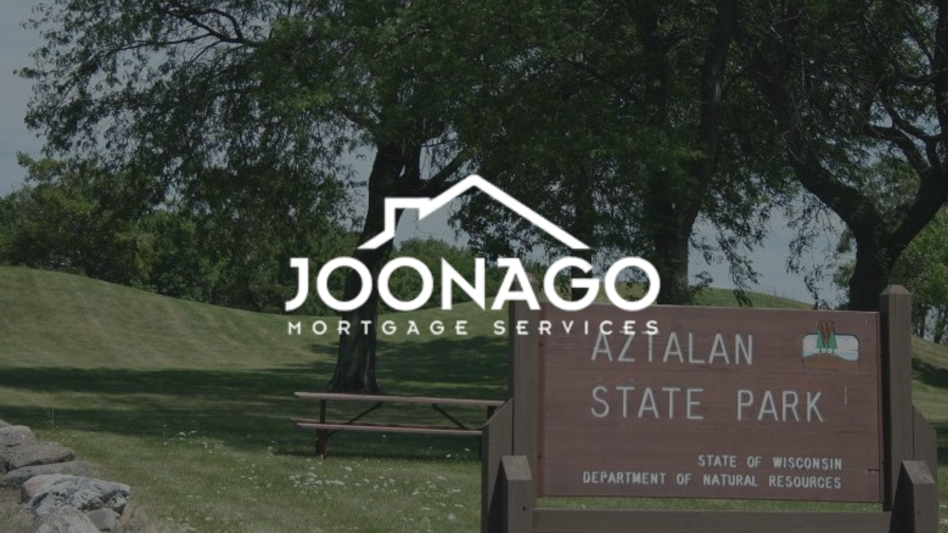 A sign that says aztalan state park on it with the joonago mortgage services logo