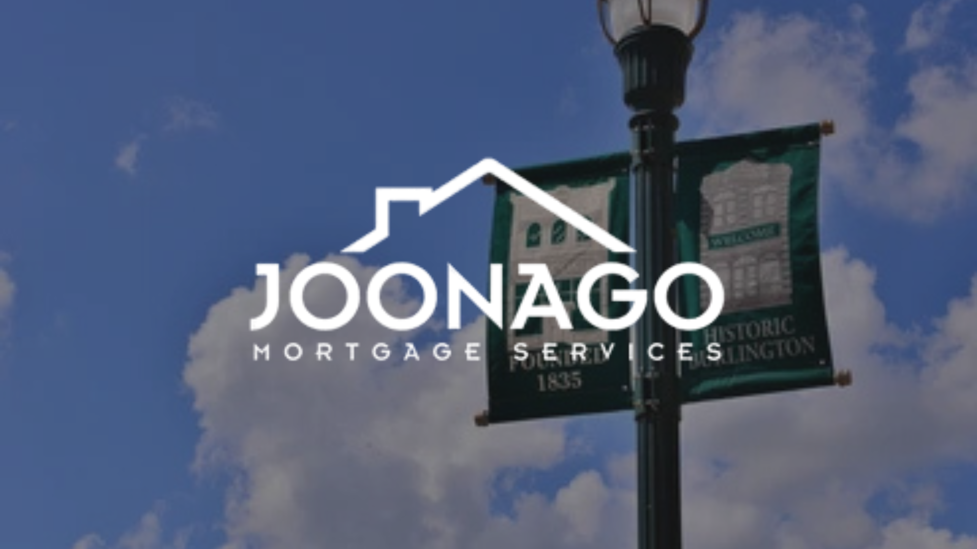 Joonago Mortgage Services logo with a house icon on a banner in front of a blue sky.