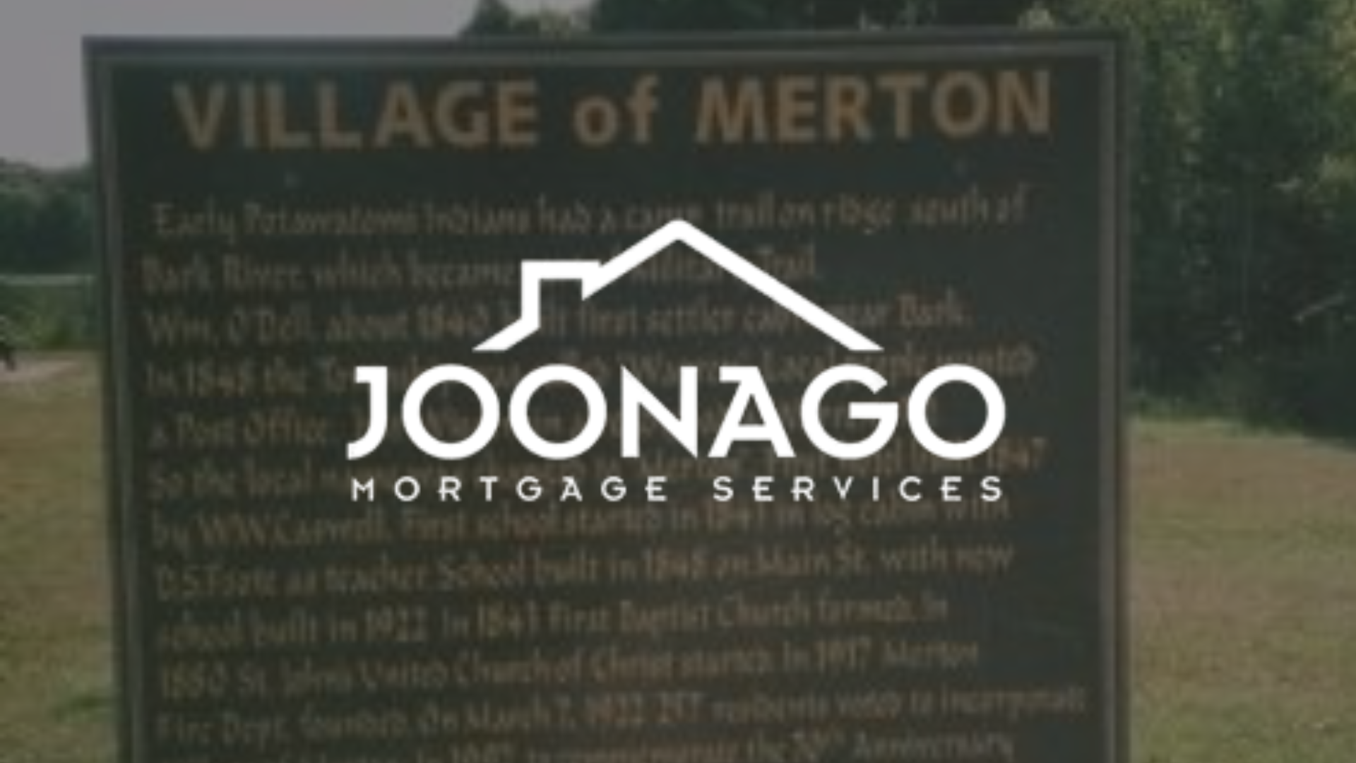 Sign for the Village of Merton, Wisconsin, with the logo of Joonago Mortgage Services superimposed.