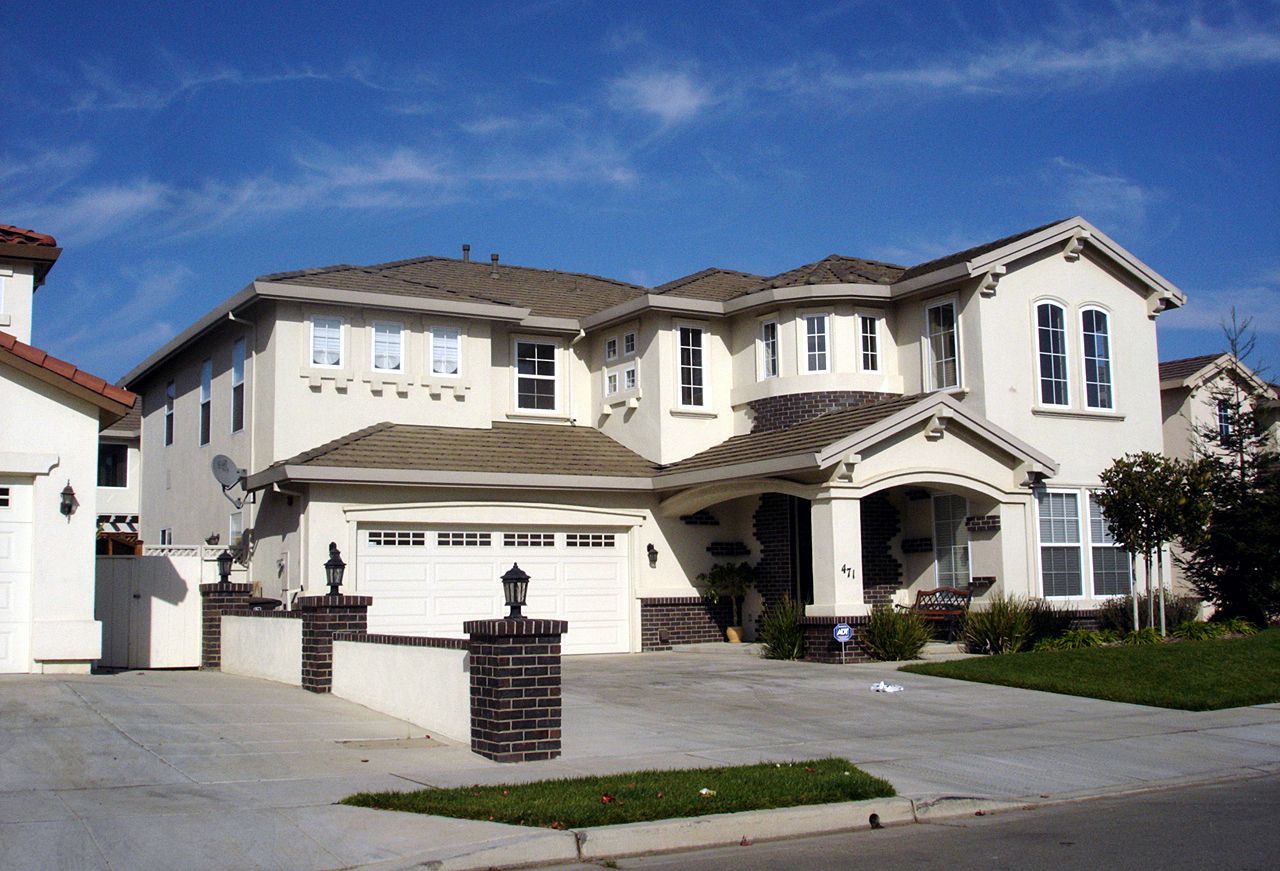 A large white house with a brown roof