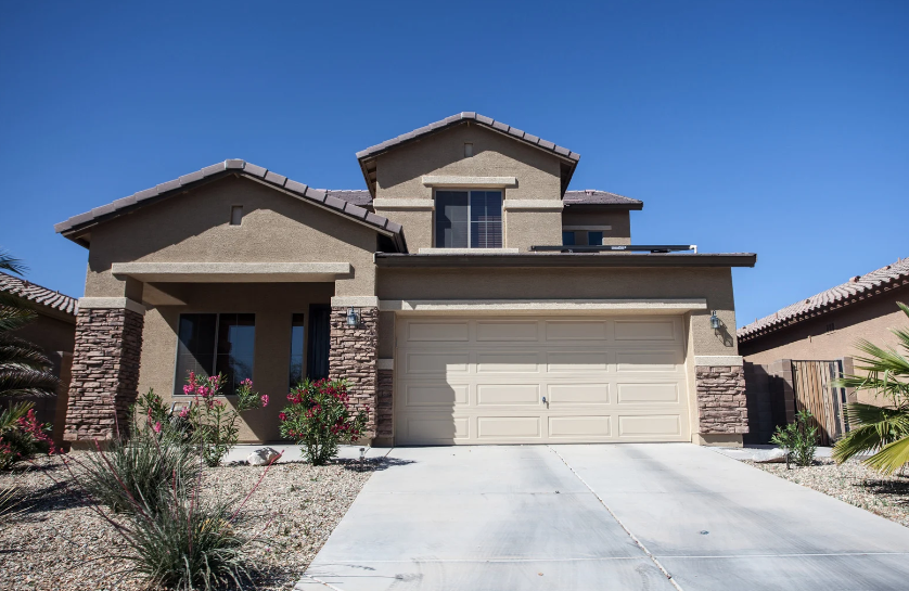 A large house with a concrete driveway in front of it, located in arizona, and sold by Joe Huljak of Joonago Mortgage