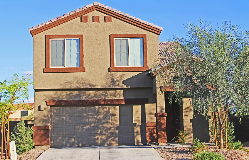 A house with a lot of windows and a driveway sold by Joe Huljak of Joonago Mortgage