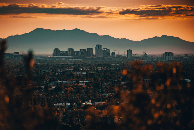 phoenix arizona skyline with mountains in the background at sunset.