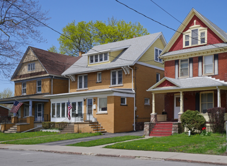 A row of houses are lined up on a sunny day