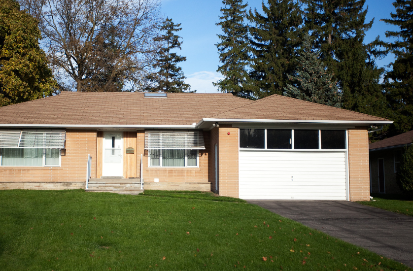 A house with a brown roof and a white garage door