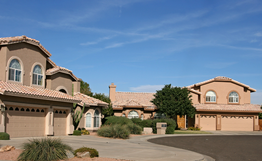 A couple of houses are sitting next to each other in a residential area.