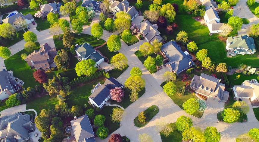 An aerial view of a residential neighborhood filled with lots of houses and trees.