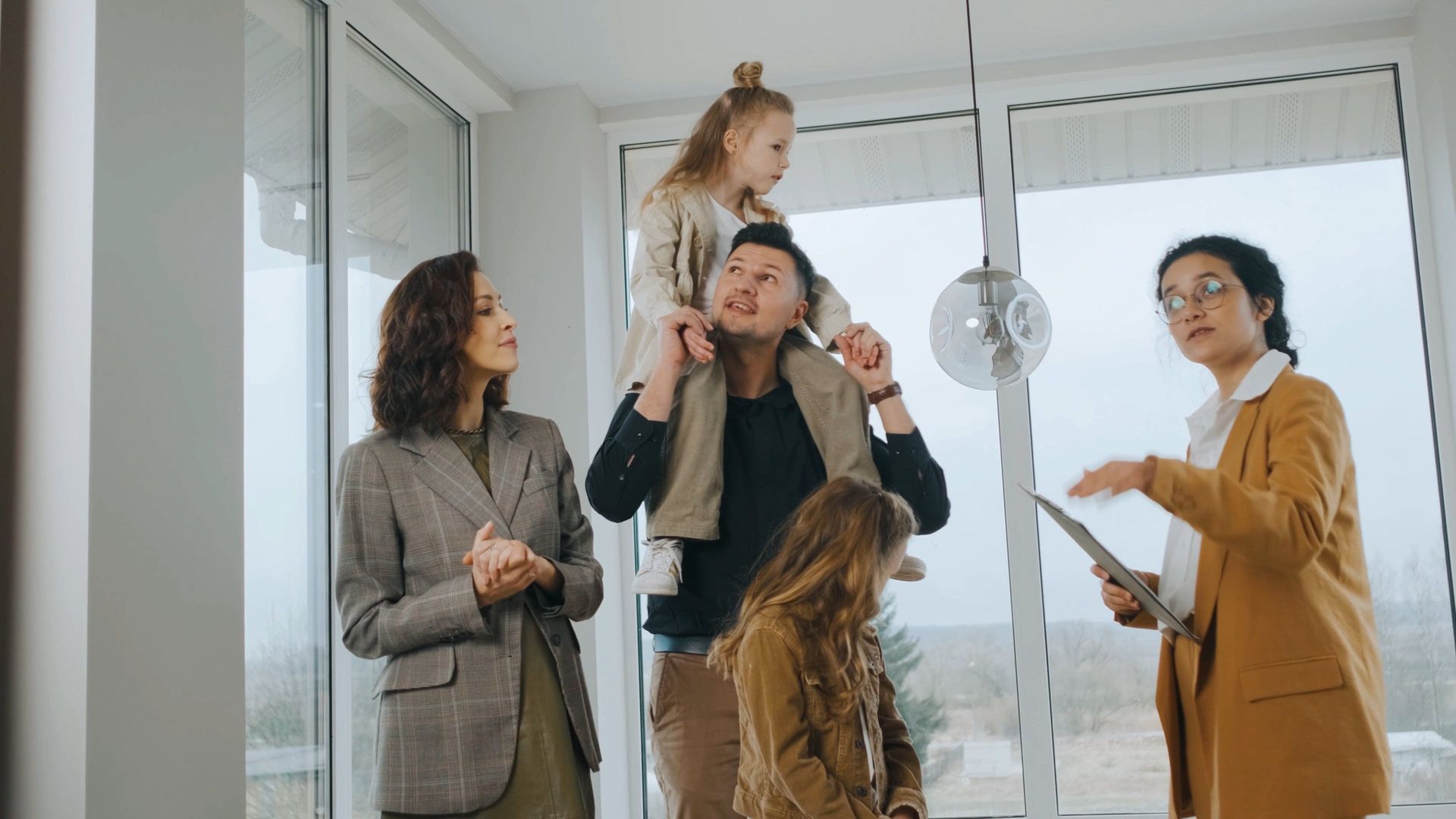 A family is looking at a house with a real estate agent.