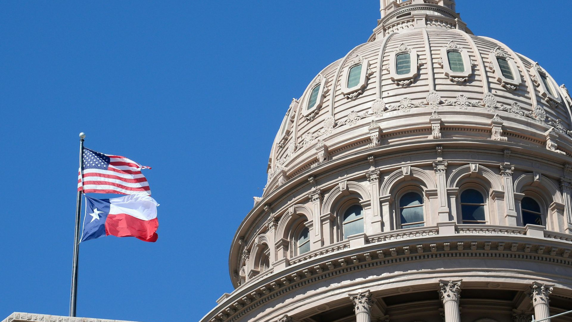 A large arizona house with a large garage and a blue sky in the background.