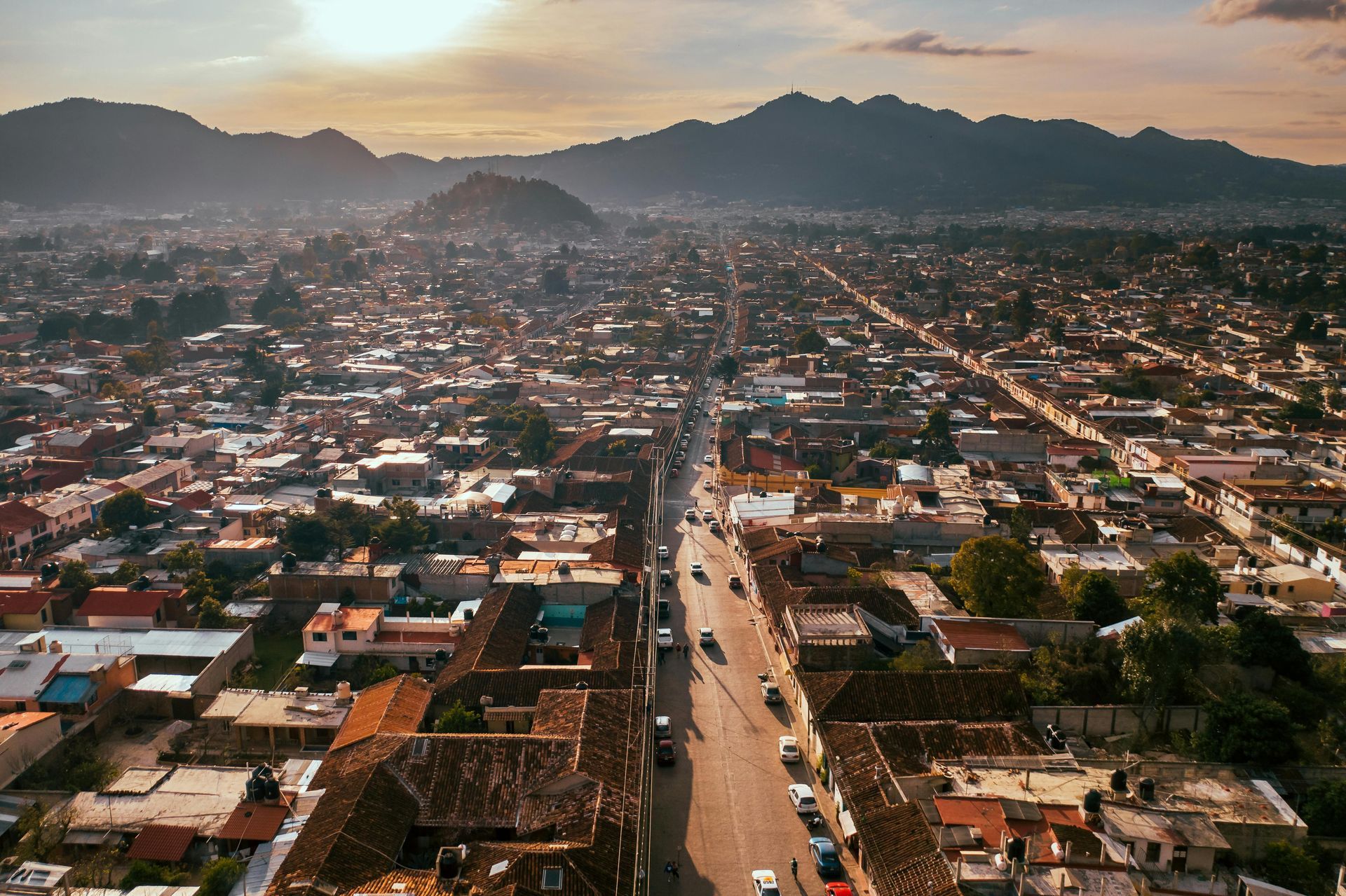 An aerial view of an arizona city with mountains in the background.