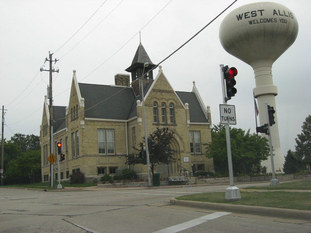 A water tower that says west allis on it