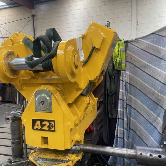 A yellow heavy machinery attachment with an 