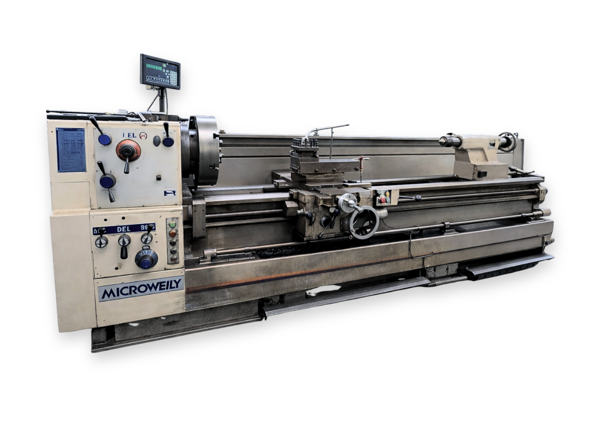 Large gray industrial lathe machine in a workshop, with control panel and windows in the background Large gray industrial lathe machine in a workshop, with control panel and windows in the background