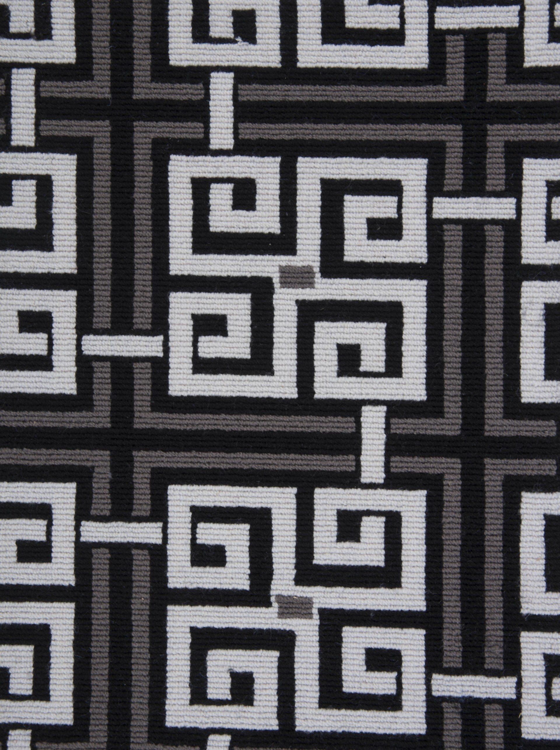 Geometric patterned fabric in white, gray, and black.