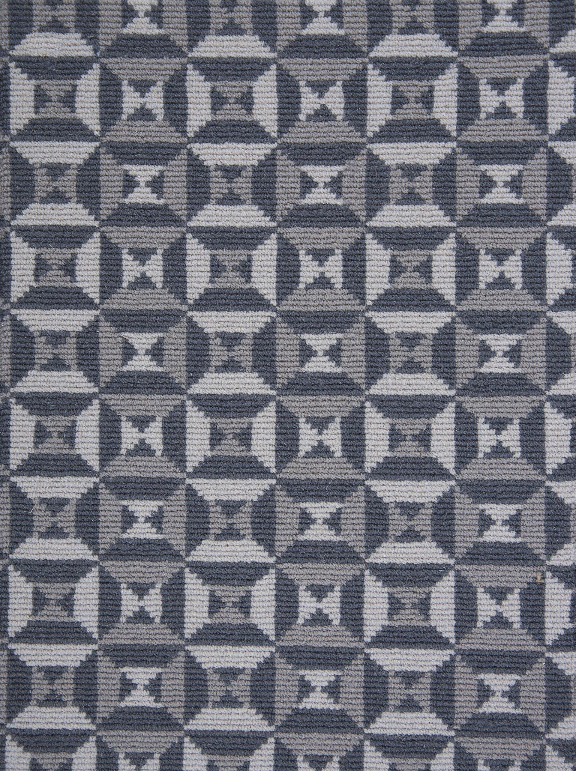 Geometric pattern of interlocking squares in shades of gray and blue.