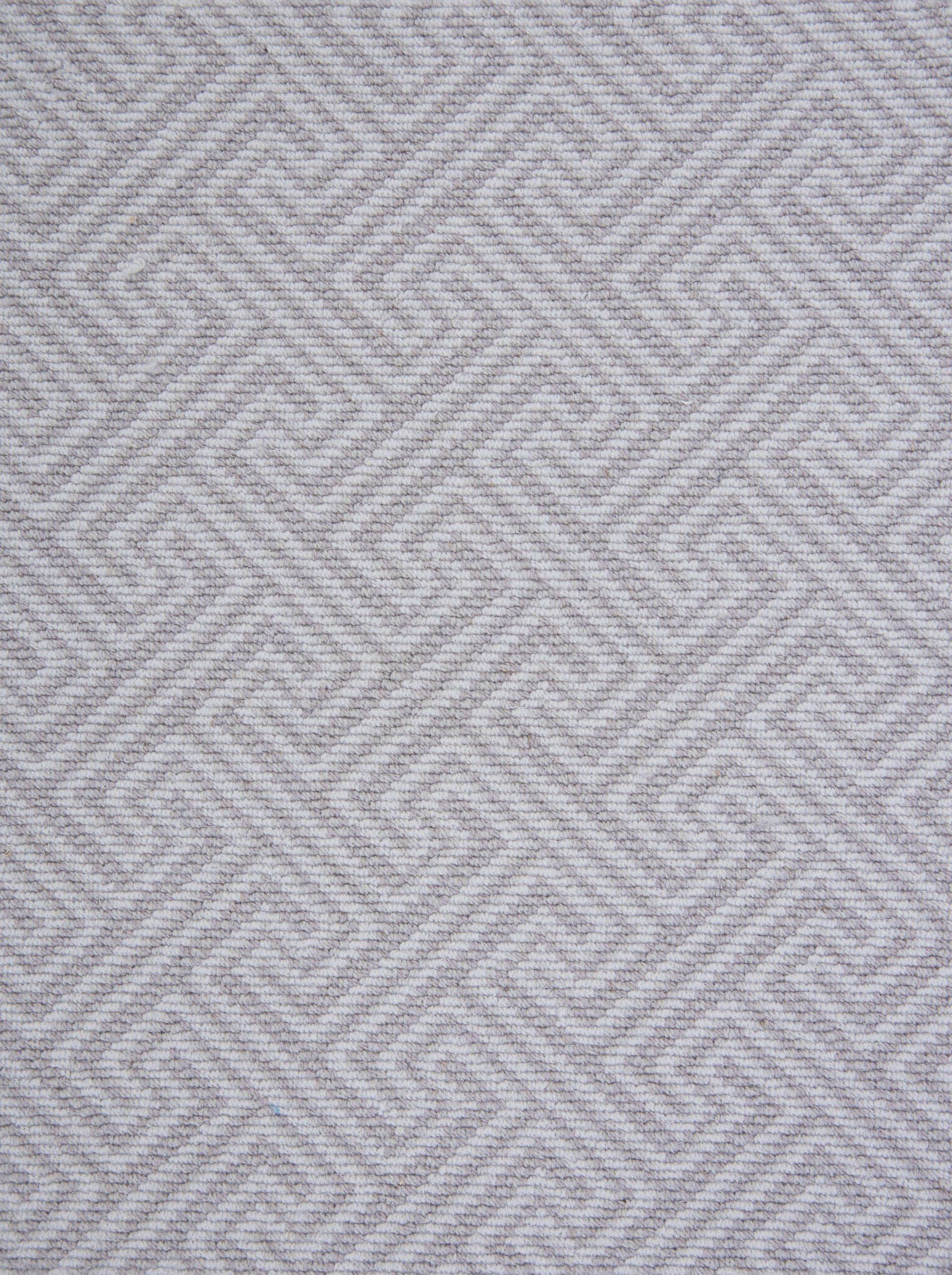 Gray and white woven fabric with a geometric maze-like pattern.