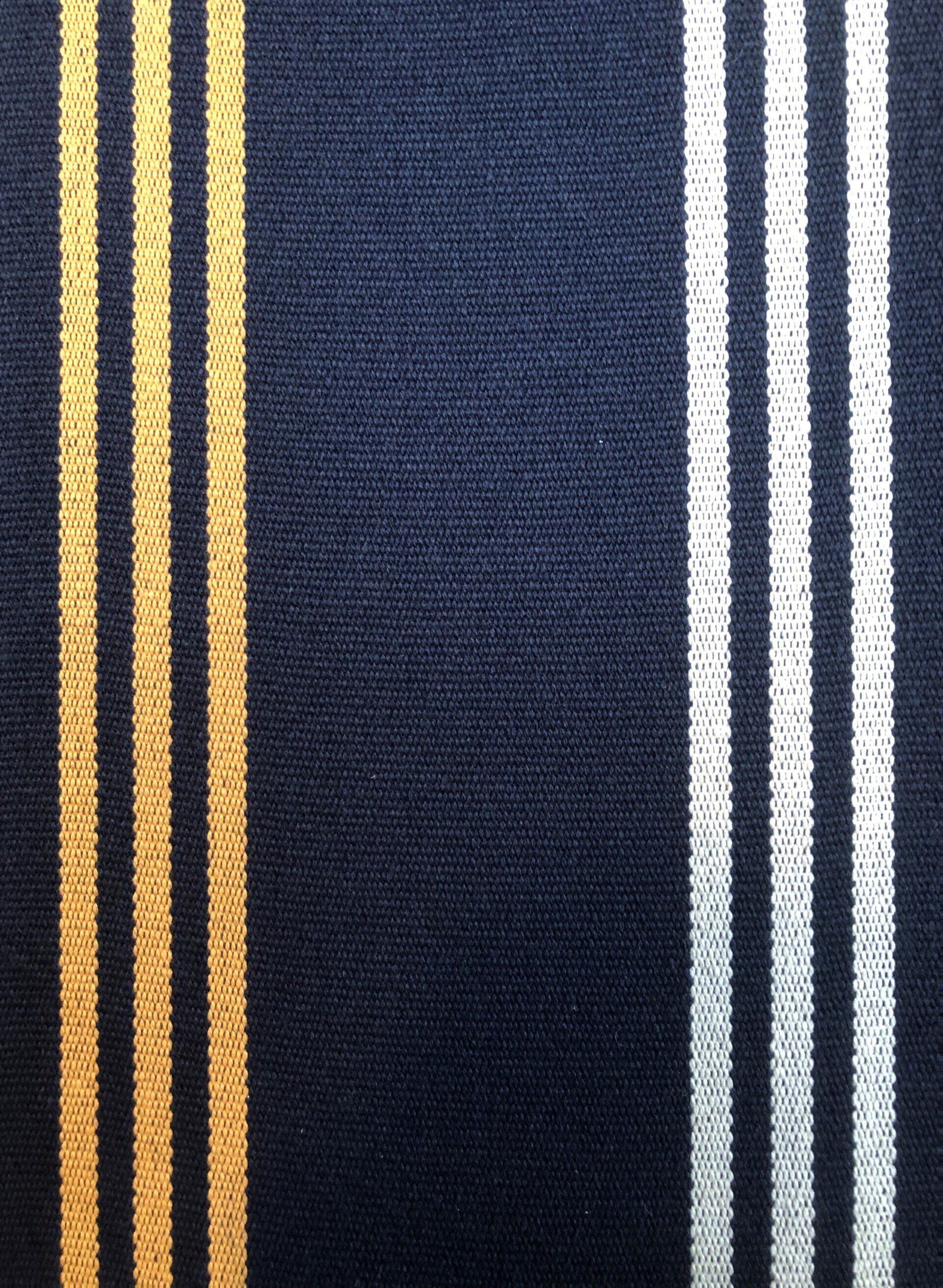 Dark blue fabric with vertical stripes: gold on the left, white on the right.